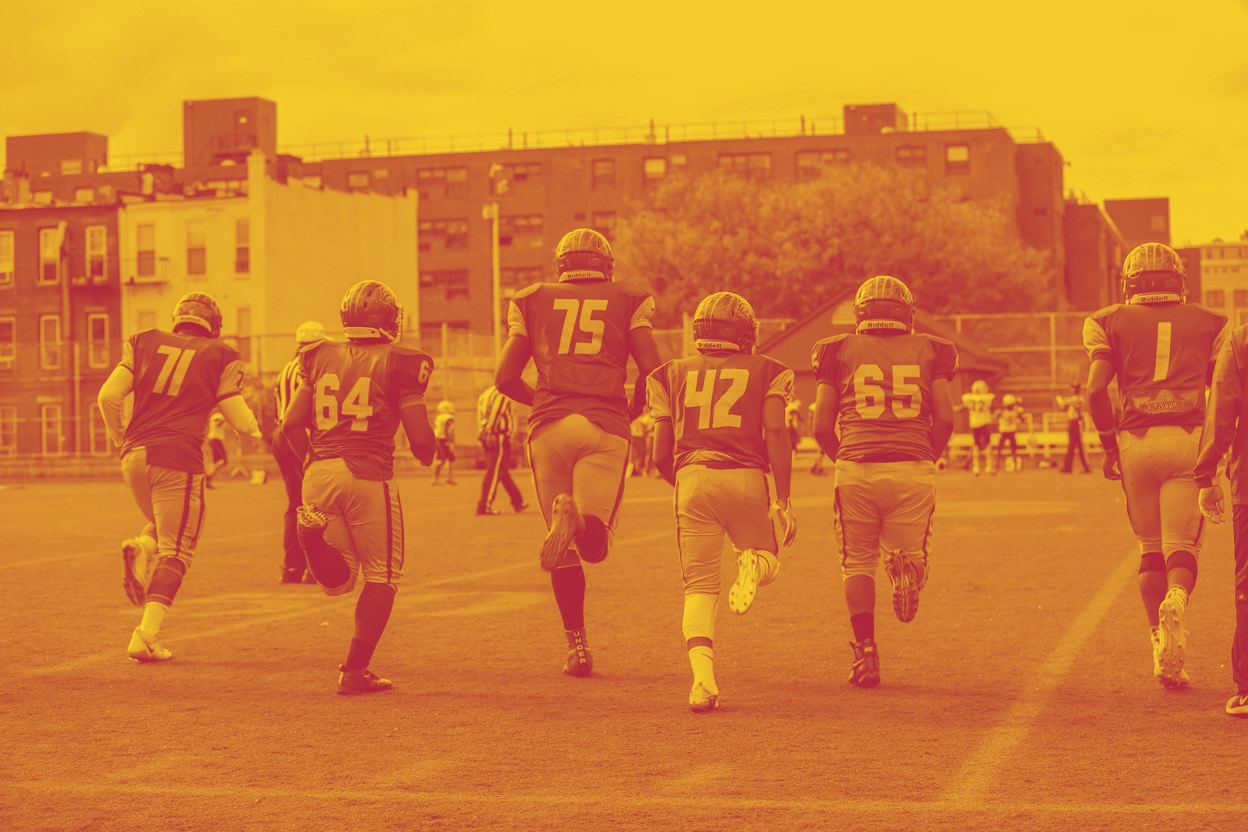 FDA football players on the field during a game.