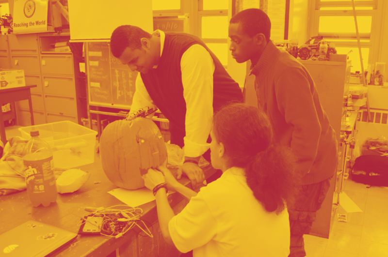 Students working on hardware during a hackathon.