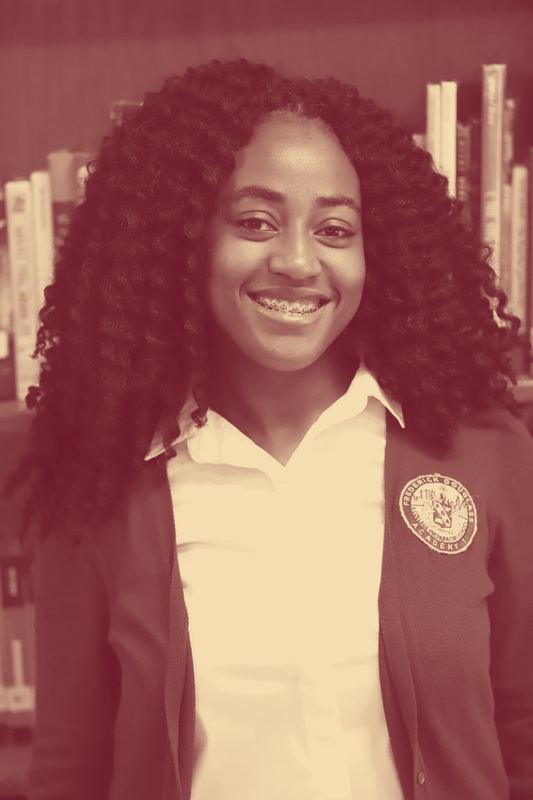 A Frederick Douglass Academy middle school student wearing the maroon crested cardigan.